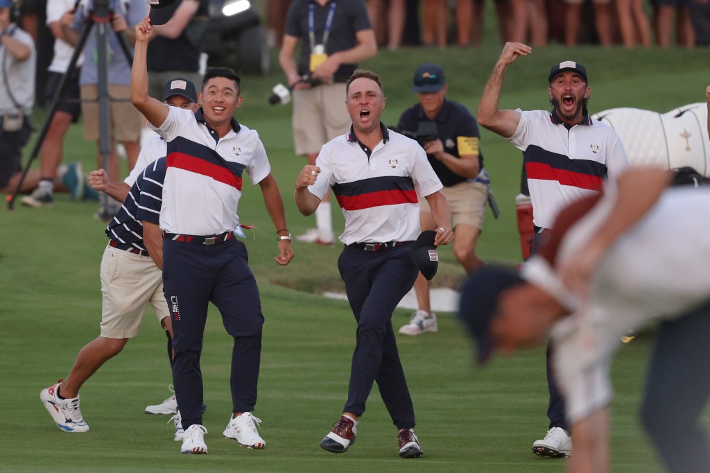 Collin Morikawa, Justin Thomas and Max Homa of Team United States celebrate on the 18th green during the Saturday afternoon fourball matches.