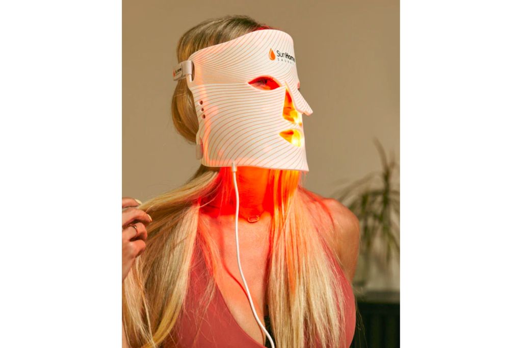 Woman wearing a LED therapy mask.