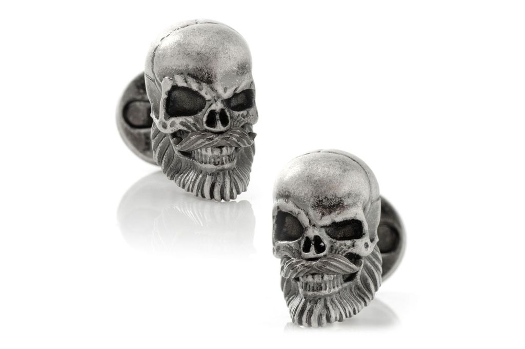 A pair of grinning skull cuff links.