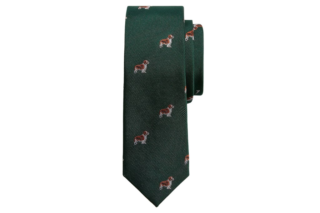 Green men's tie with embroidered brown and white dogs on the front of it.