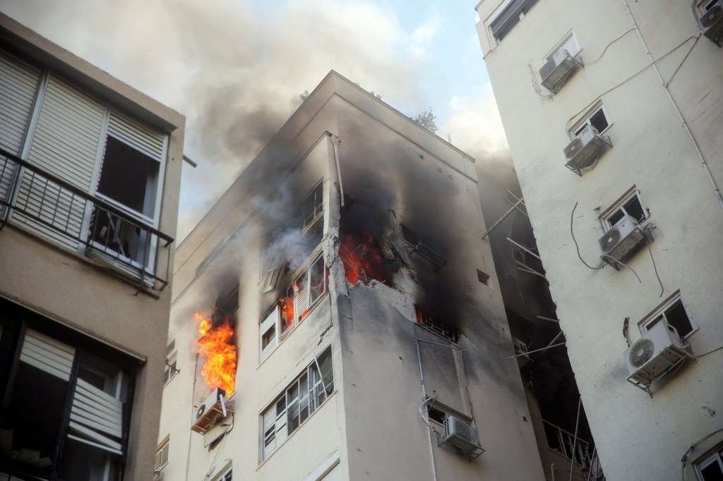 A building is ablaze following rocket attacks from the Gaza Strip, in Tel Aviv, Israel October 7, 2023. 