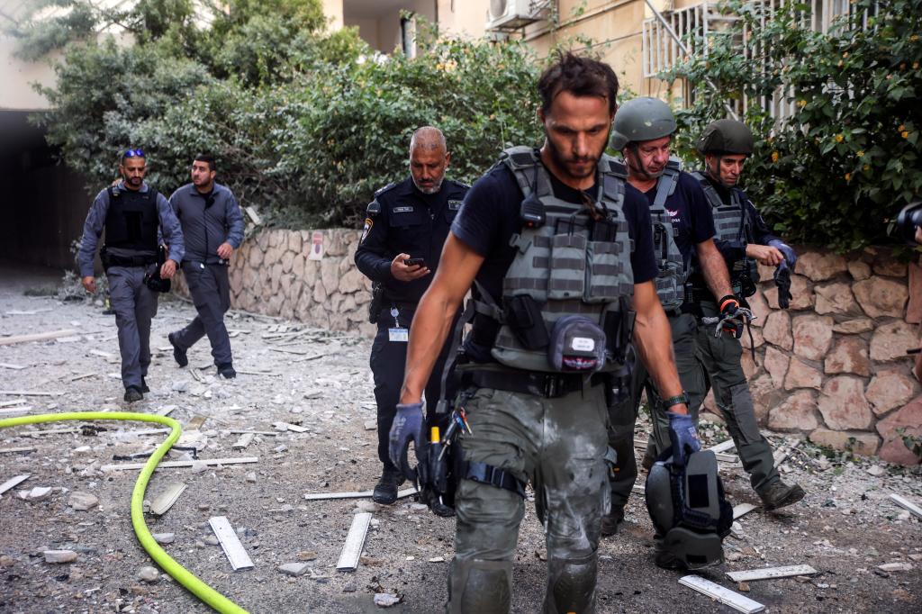 Israeli police and other security officials work as rockets are launched from the Gaza Strip, in Tel Aviv, Israel October 7, 2023.