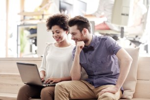 A couple researches high-yield savings accounts.