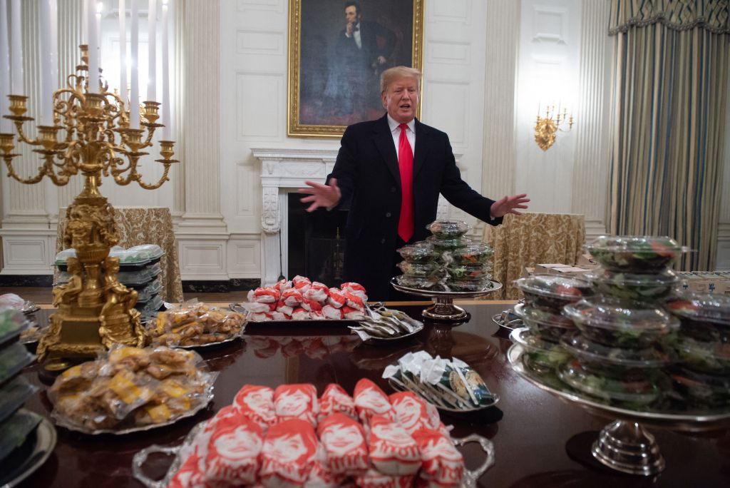 US President Donald Trump speaks alongside fast food he purchased for a ceremony honoring the 2018 College Football Playoff National Champion Clemson Tigers.
