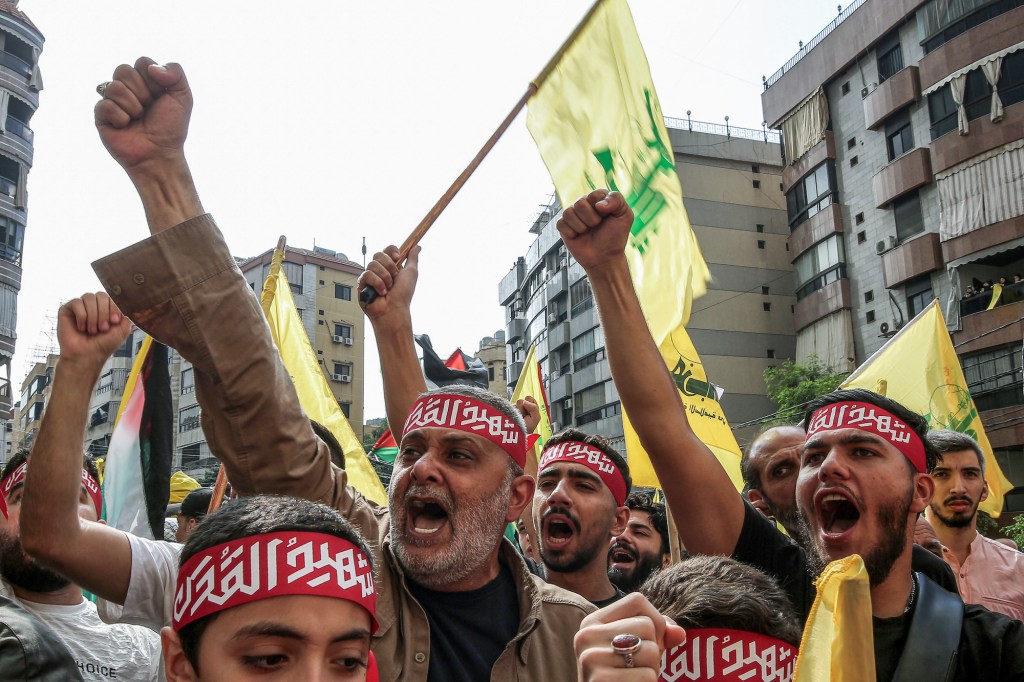 Lebanese protesters carry Hezbollah flags in solidarity with Palestinians