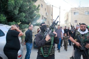 Armed men from Hamas fired into the air during a funeral.