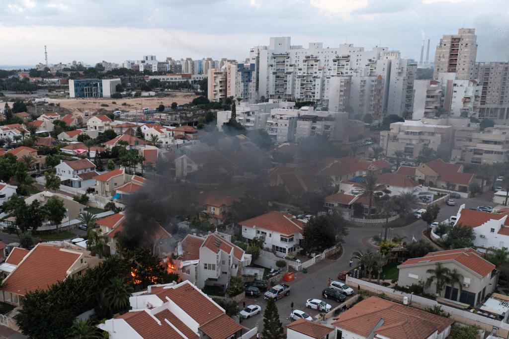 Smoke rises after a rocket fired from the Gaza Strip hit a house in Ashkelon, southern Israel, Saturday, Oct. 7, 2023