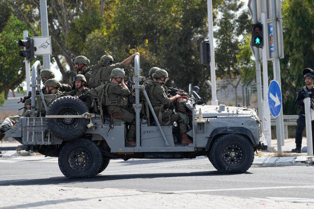 Israeli soldiers head south near Ashkelon, Israel, Israel, on Saturday, Oct. 7, 2023. Palestinian militants in the Gaza Strip infiltrated Saturday into southern Israel and fired thousands of rockets into the country while Israel began striking targets in Gaza in response.