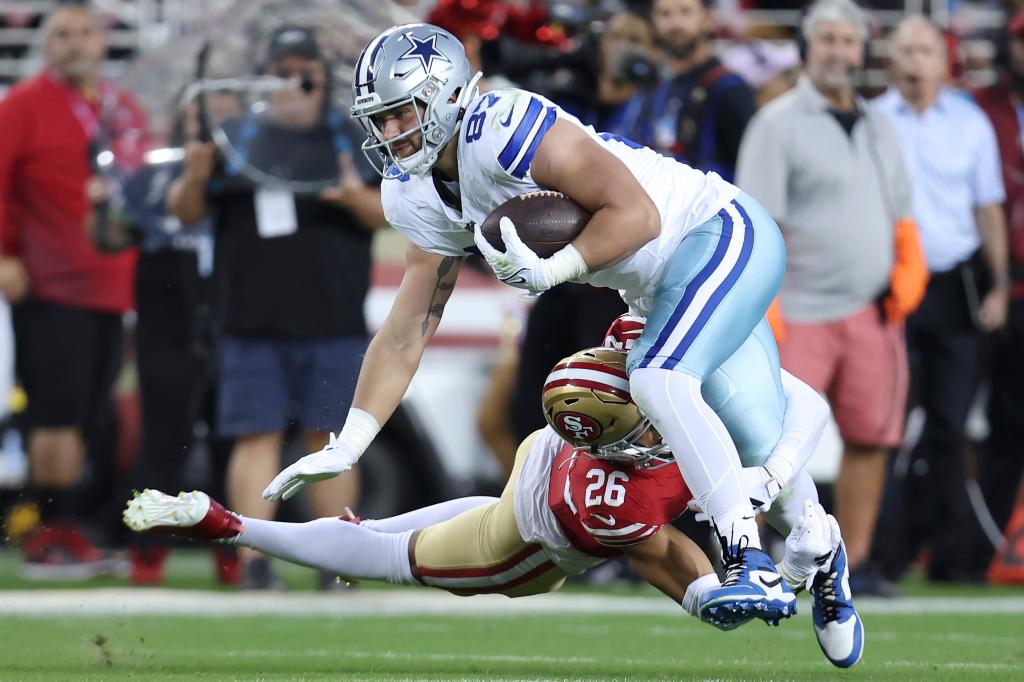  Cowboys tight end Jake Ferguson, top, is tackled by San Francisco 49ers cornerback Isaiah Oliver