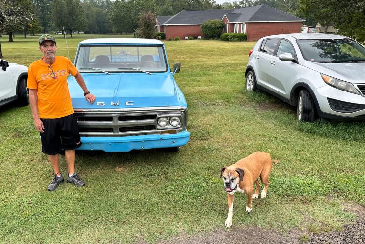 Ricky Dority in front of car and with dog