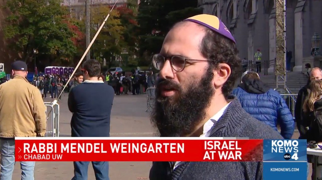 Chabad Rabbi Mendel Weingarten is pictured speaking with KOMO news.