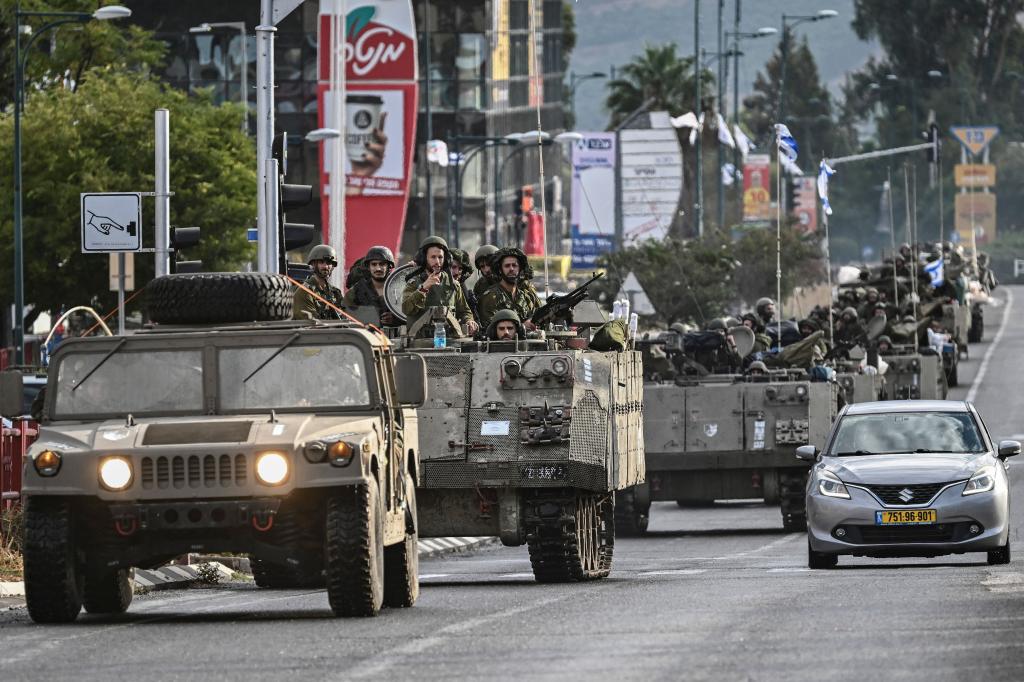 Israeli soldiers patrol in armoured personnel carriers at an undisclosed position in northern Israel near the border with Lebanon on October 15, 2023. 