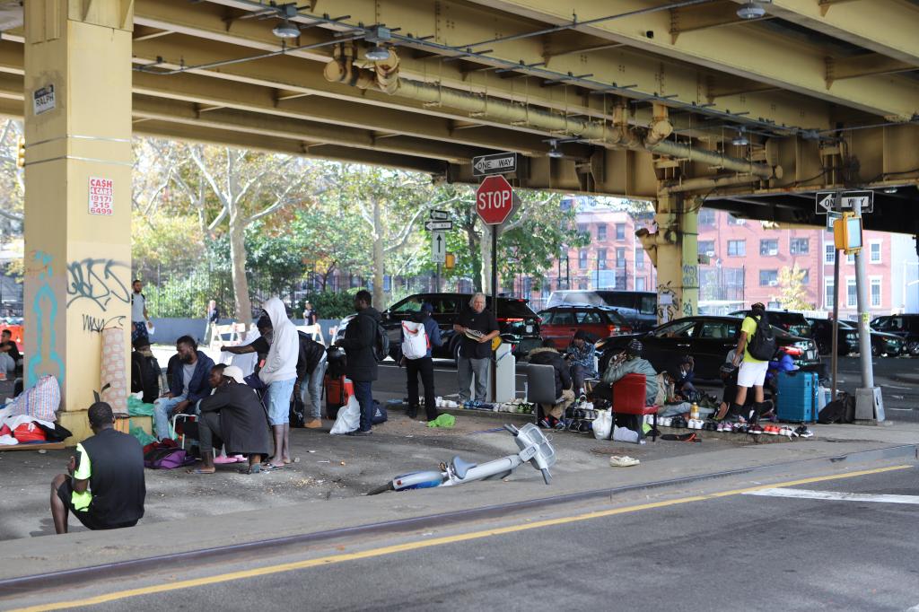 Migrants living underneath a stretch of the Brooklyn-Queens Expressway in Brooklyn on October 28, 2023.