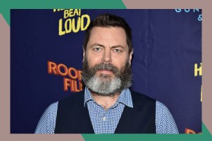 Nick Offerman poses on the red carpet with a bemused look.