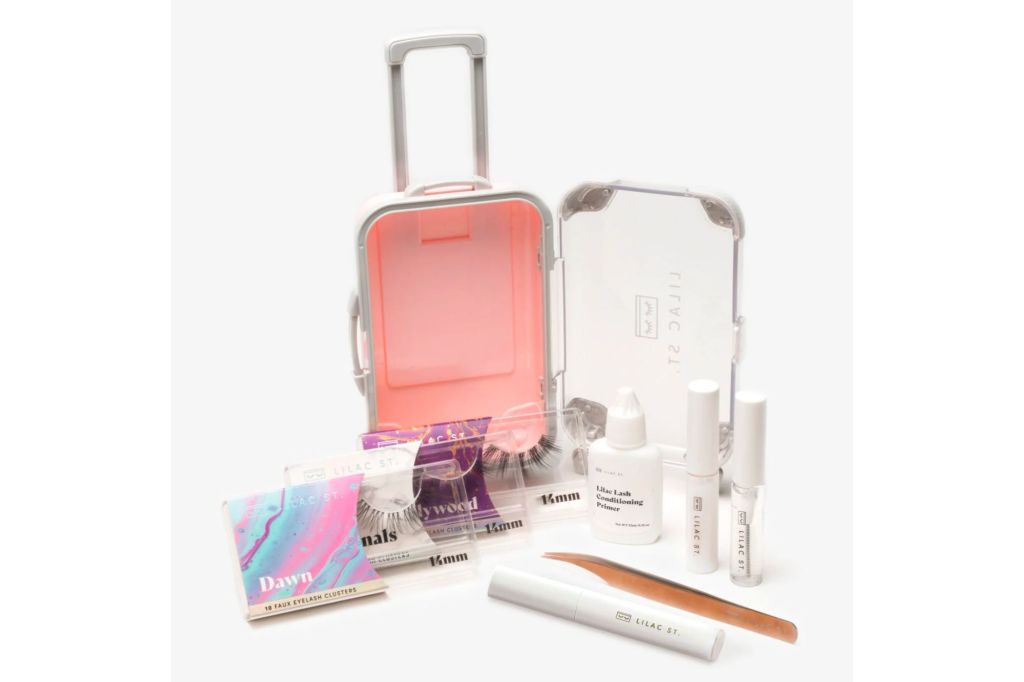 A travel kit that looks like a mini suitcase and faux lashes and application tools.