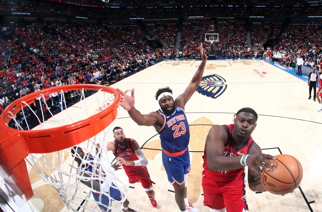 Zion Williamson, who scored 24 points, goes up for a layup after driving past Mitchell Robinson during the Knicks' loss.