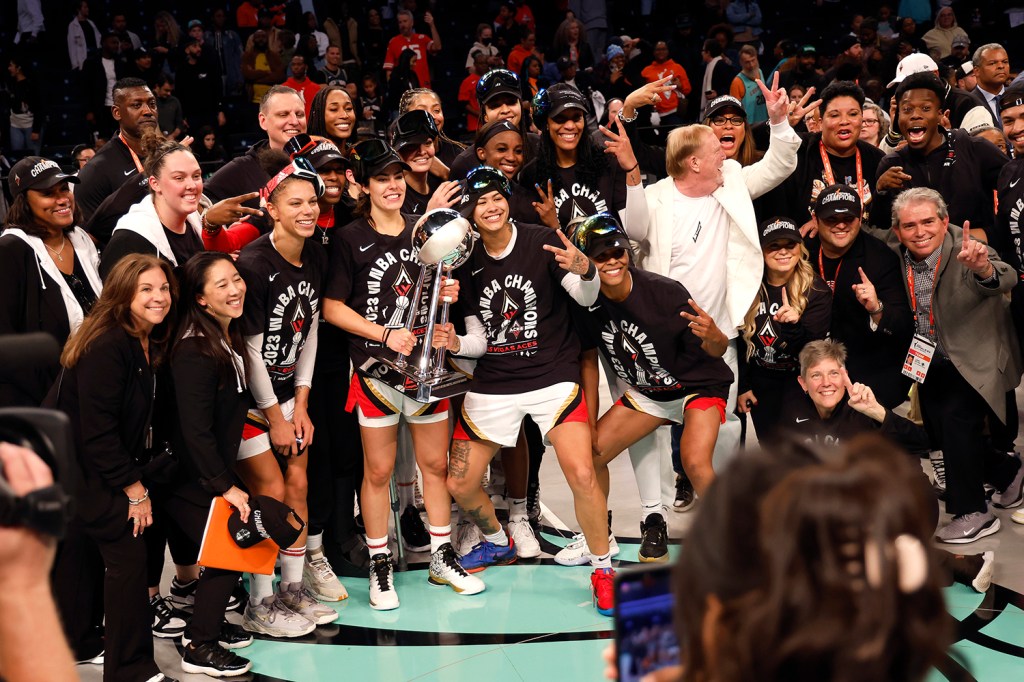 Las Vegas Aces guard Kelsey Plum holds the championship trophy while celebrating with her team after defeating the New York Liberty in Game 4 of the 2023 WNBA Finals at Barclays Center on October 18, 2023 in New York City. 