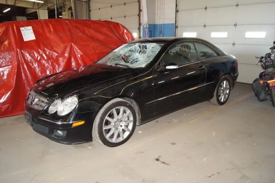 photo of black mercedes with shattered windshield