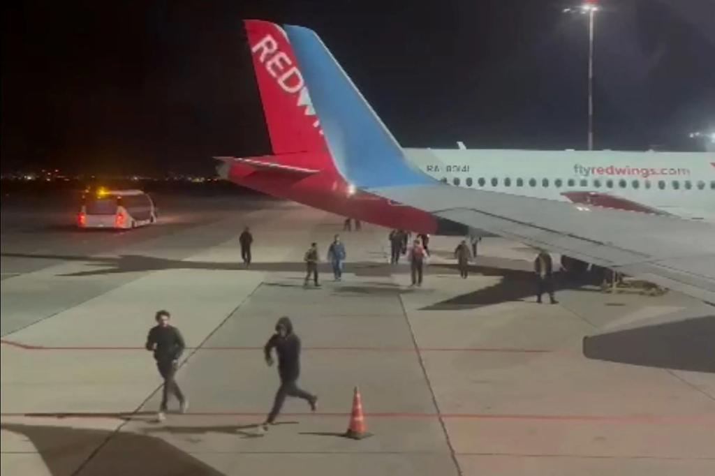 This frame grab taken from video footage on Oct. 29, 2023 shows protestors running on the apron area of an airport in Makhachkala.