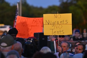 Hundreds gather for an anti-migrant rally at Floyd Bennett Field