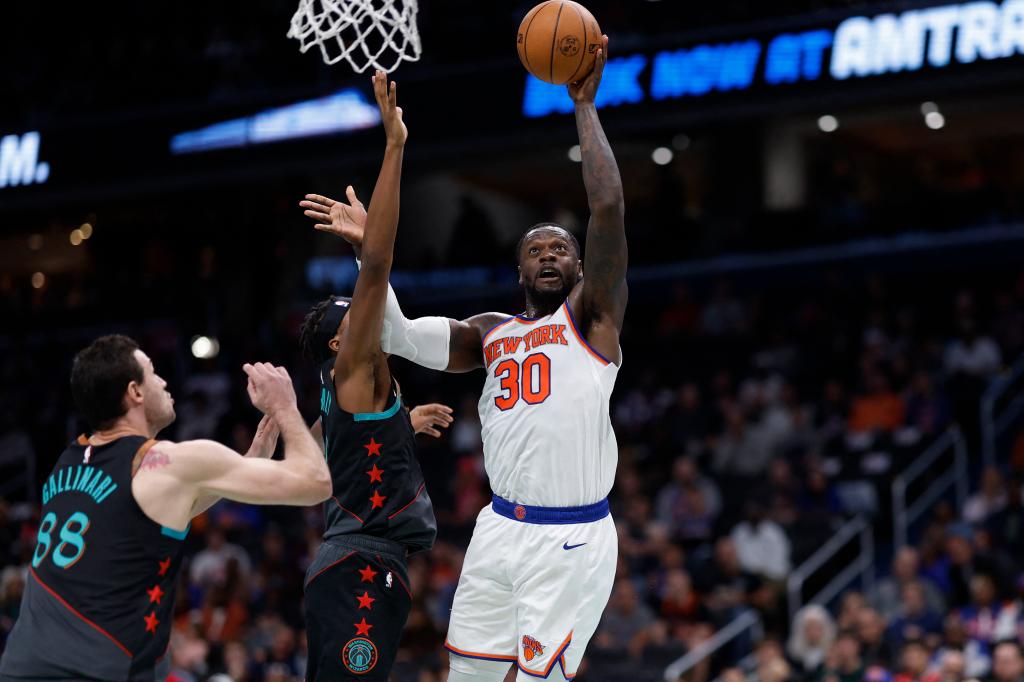 New York Knicks forward Julius Randle (30) shoots the ball as Washington Wizards guard Bilal Coulibaly (0) defends in the first quarter at Capital One Arena.