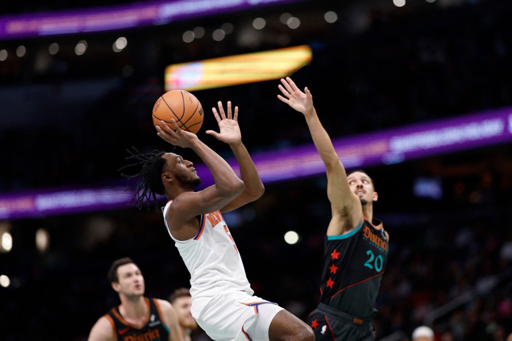 New York Knicks guard Immanuel Quickley (5) shoots the ball as Washington Wizards guard Landry Shamet (20) defends in the second quarter at Capital One Arena.