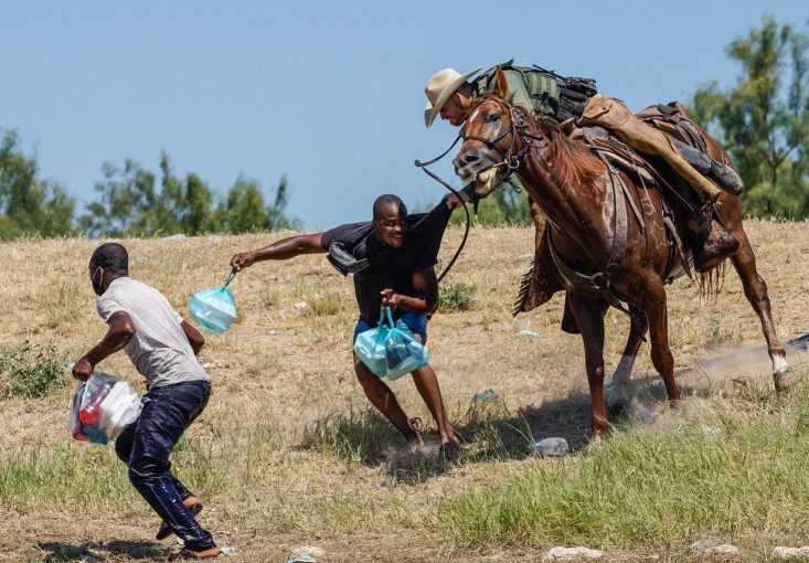 A United States Border Patrol agent on horseback tries to stop a Haitian migrant from entering an encampment on the banks of the Rio Grande near the Acuna Del Rio International Bridge in Del Rio, Texas on Sep. 20, 2021. 