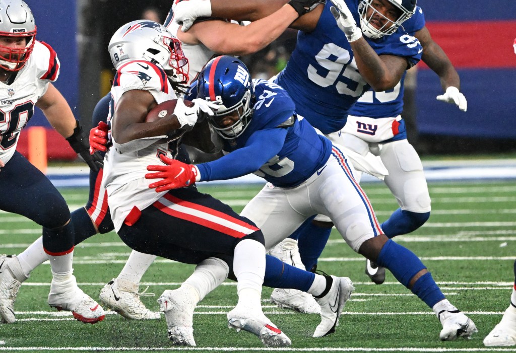 Bobby Okereke, wh has been one of the Giants' best free-agent signings in recent history, tackles Rhamondre Stevenson during the Giants' 10-7 win over the Patriots. 