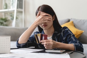 A woman is stressed about her credit card balance.