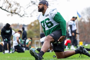 Duane Brown does some stretching exercise during practice.