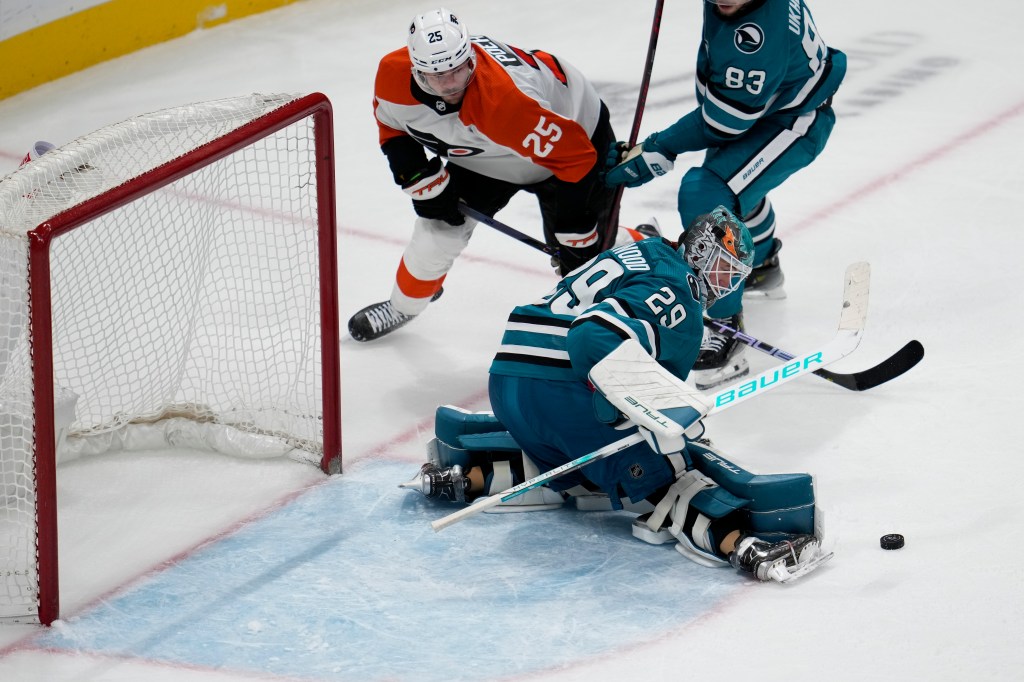 San Jose Sharks goaltender Mackenzie Blackwood (29) narrowly blocks a key shot during the third period against the Flyers. 