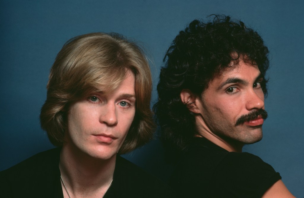 American rock and soul duo Hall & Oates (American singer-songwriter and musician Daryl Hall, and American singer-songwriter and guitarist John Oates) in a studio portrait, against a blue background, circa 1980. (Photo by Lynn Goldsmith/Corbis/VCG via Getty Images)