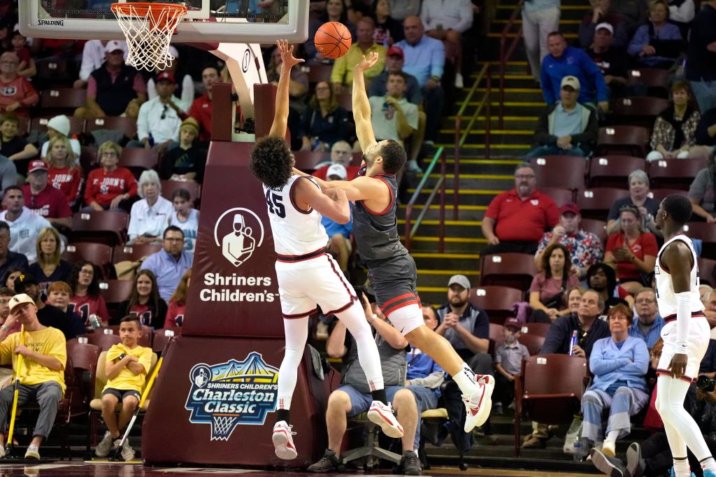 Chris Ledlum #8 of the St. John's Red Storm drives to basket over Zimi Nwokeji #45 of the Dayton Flyers