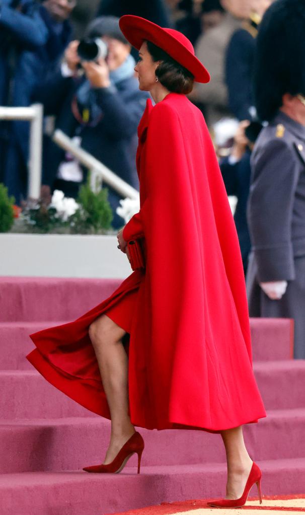 The Princess of Wales wore a stunning red hat by Jane Taylor and a matching wool cape by Catherine Walker & Co. for the cermony.