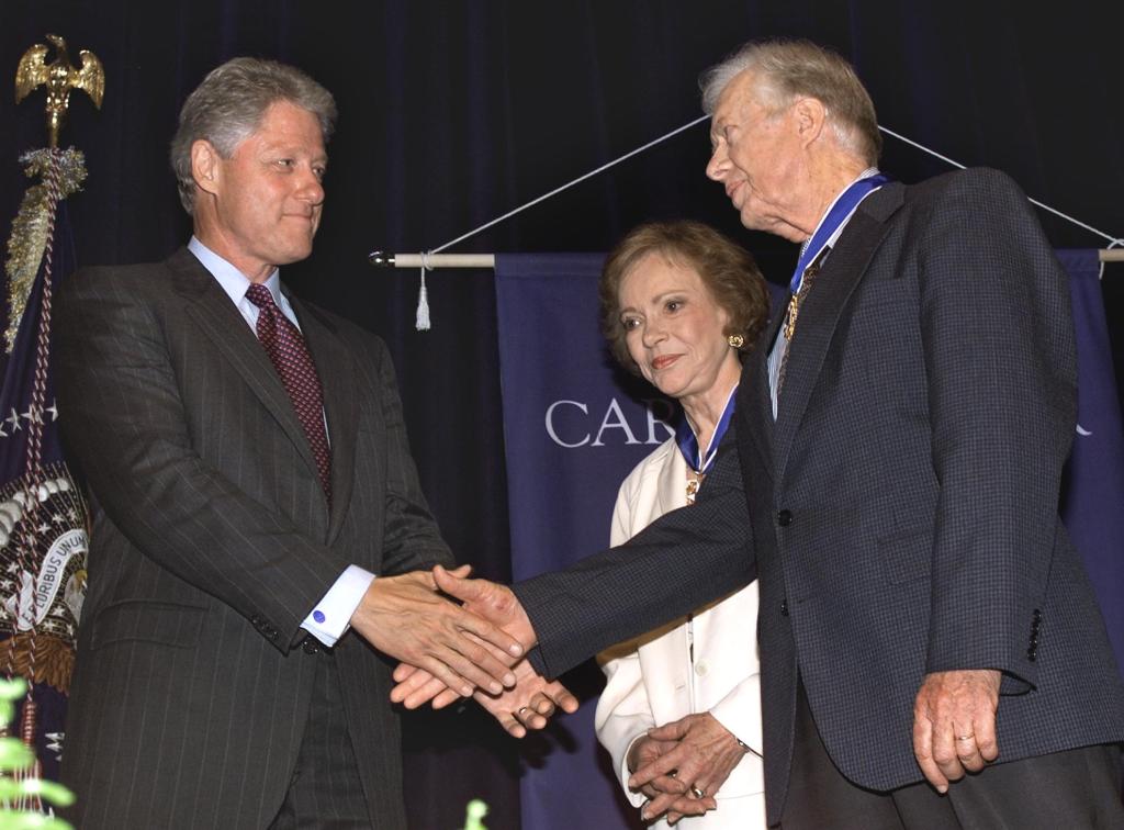 President Bill Clinton awarding the Medal of Freedom to Rosalynn and Jimmy Carter on Aug. 9, 1999.