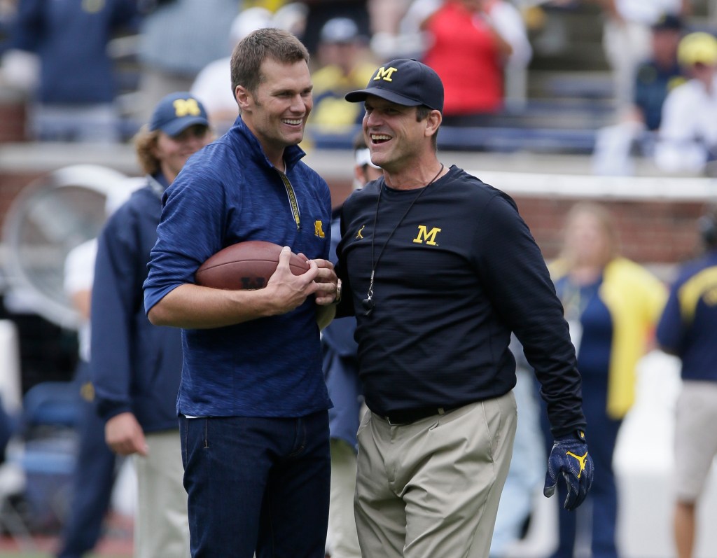 Tom Brady (L.) embraces Jim Harbaugh.