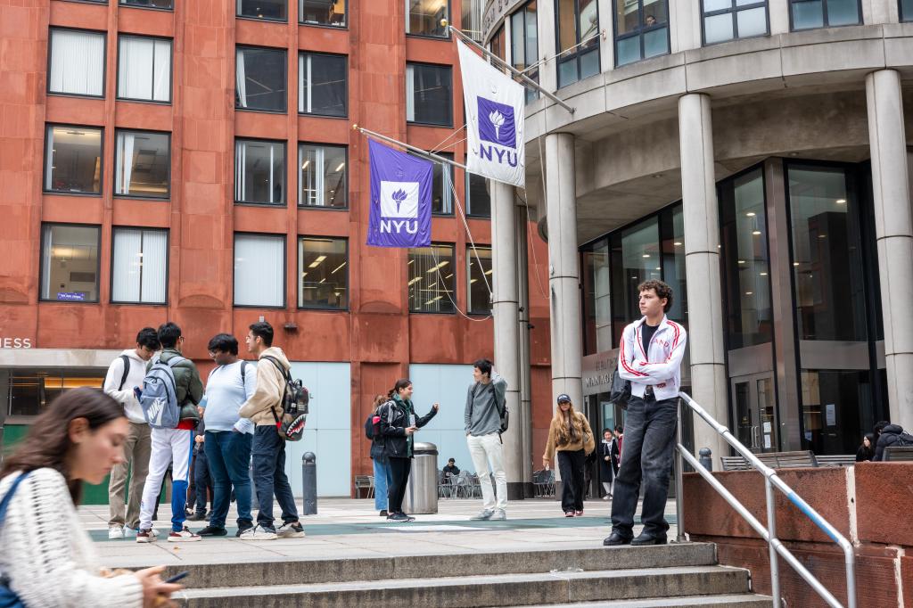 NYU building, students milling in front