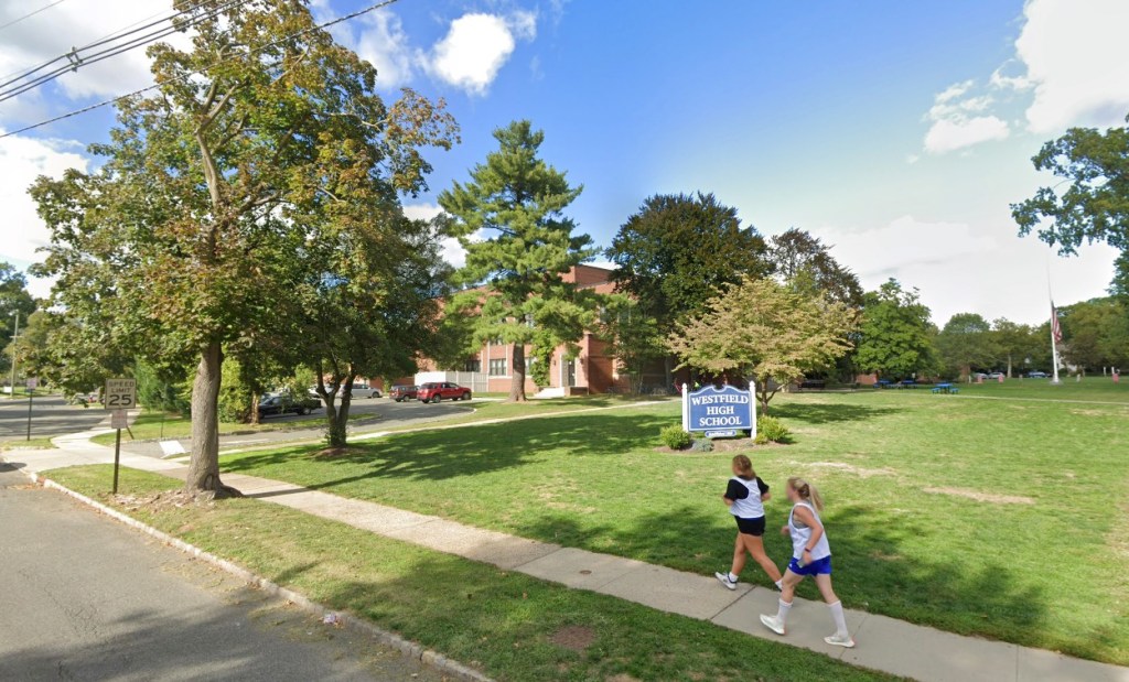 Girls running past Westfield High School sign