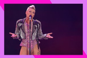 Pink sings onstage in concert.