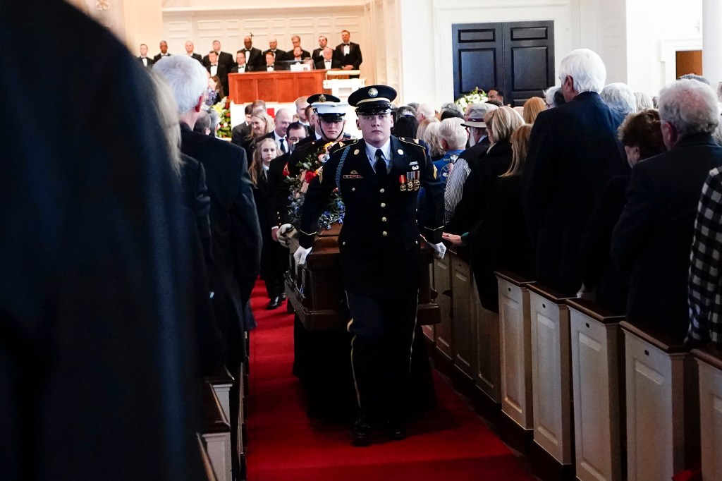 An Armed Forces body bearer team moves the casket of former first lady Rosalynn Carter after a tribute service at Glenn Memorial Church at Emory University on Tuesday, Nov. 28, 2023, in Atlanta.