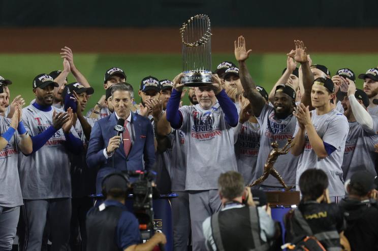 Manager Bruce Bochy of the Texas Rangers hoists the Commissioner's Trophy.