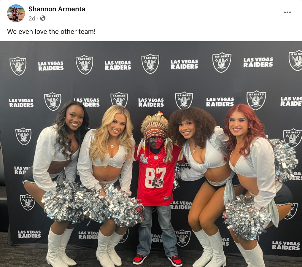Holden Armenta poses with the Raiders cheerleaders.