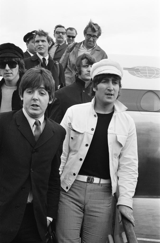 The Beatles and Mal Evans exiting a plane.