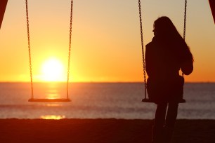 Single woman alone on a swing.