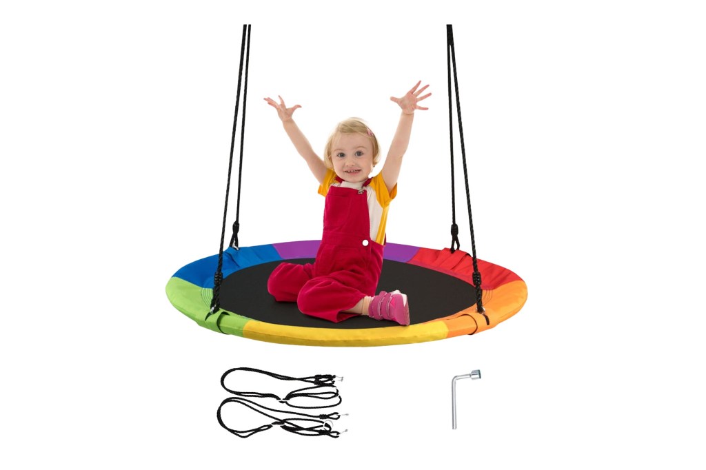 Young girl sitting on rainbow trampoline