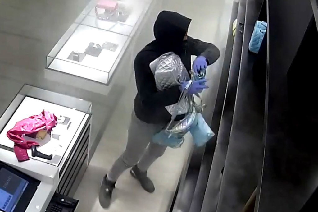 Shocking surveillance footage shows the group charging into the upscale retail store around 5:30 p.m. and grabbing as many handbags as they can stuff into their arms.