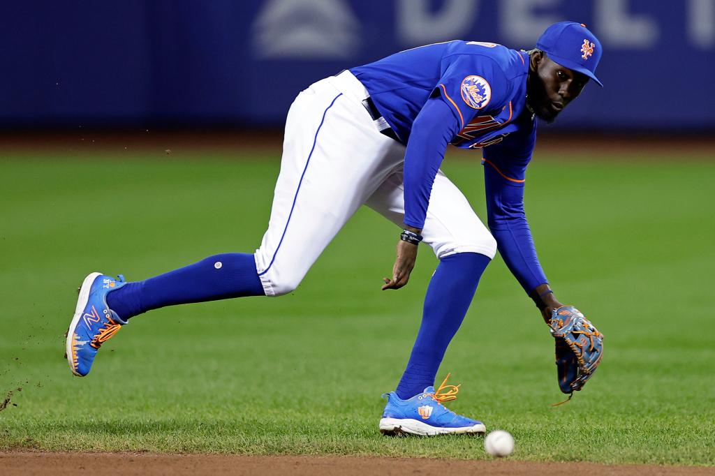 Ronny Mauricio #10 of the New York Mets tries to field a ground ball against the Philadelphia Phillies