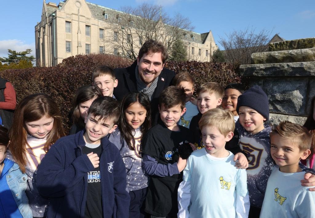 122923 Showing Teacher Michael Califano with some of his former students. Family, Friends and Students at a Rally for Teacher Michael Califano, 26years old, at St. Agnes Cathedral at 29 Quealy Place in Rockville Center, Long Island. He was fired from the Church for not living there Lifestyle. "NYPostinhouse"