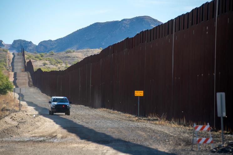 A US Customs and Border Protection vehicle drives alongside the US-Mexico border wall in Sasabe, Arizona, on December 8, 2023.
