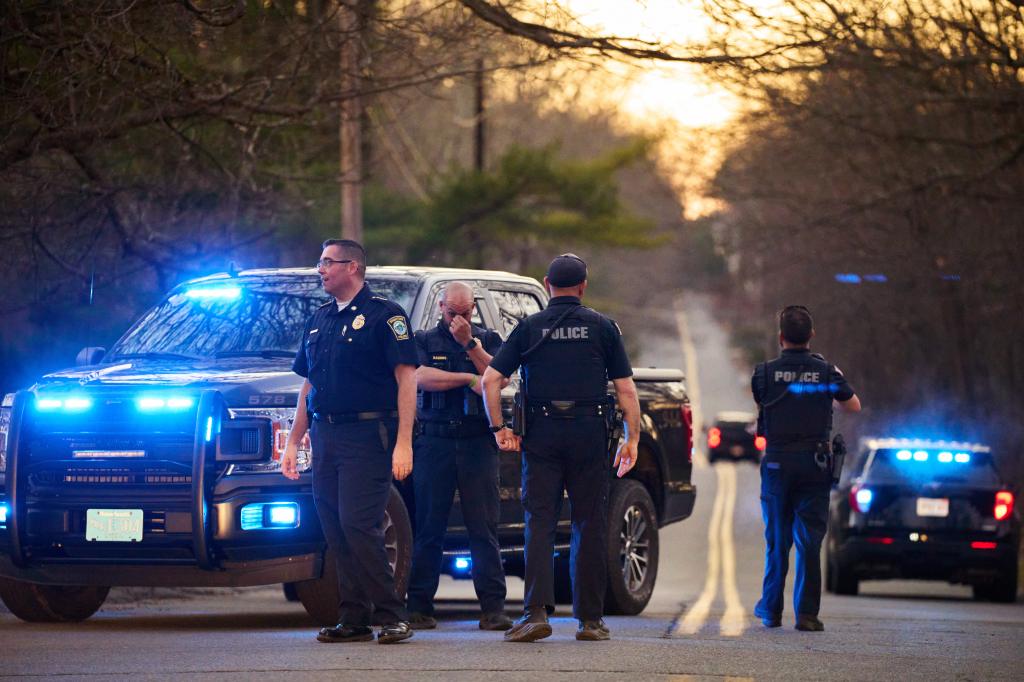 Law enforcement officers guard a road leading to the home of Massachusetts Air National Guardsman Jack Teixeira on Thursday, April 13, 2023 in North Dighton, Massachusetts.